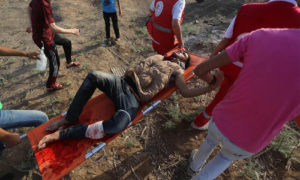 Seorang warga Palestina yang terluka terlihat setelah pasukan Israel menembakkan gas air mata pada pengunjuk rasa selama Great March of Rerturn di Gaza pada 23 Juni 2018. (Foto: Middle East Monitor/Mohammed Asad)