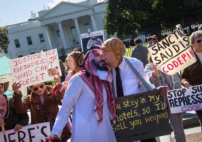 Demonstran berpakaian seperti Putra Mahkota Arab Saudi Pangeran Mohammed bin Salman dan Presiden AS Donald Trump (tengah) berpura-pura berciuman di luar Gedung Putih di Washington, DC, pada 19 Oktober 2018, menuntut keadilan atas hilangnya jurnalis Saudi, Jamal Khashoggi. (Foto: AFP)