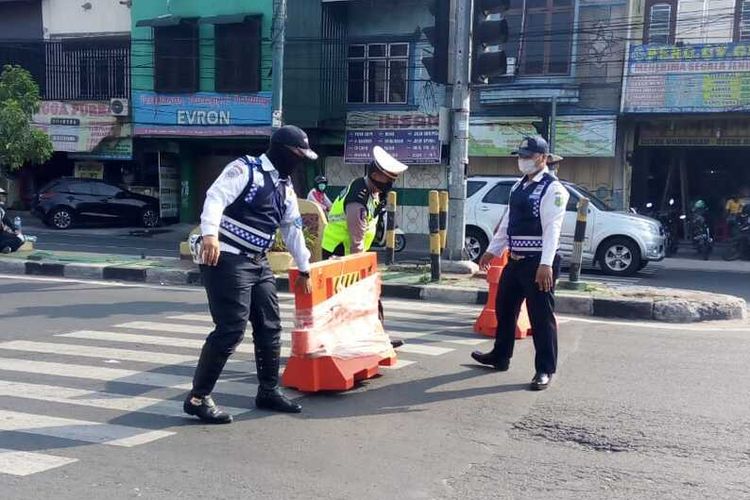 Petugas Polrestabes Medan dan Dinas Perhubungan Kota Medan menyusun water barrier di ruas Jalan Djamin Ginting-Dr. Mansyur pada Sabtu pagi, 28 Maret 2020. Sebanyak 12 ruas jalan di Kota Medan ditutup untuk membatasi mobilisasi masyarakat ke dalam kota. Kemungkinan besar akan ada penambahan ruas jalan lainnya yang akan ditutup.